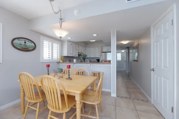 a view of a dining room with furniture and a chandelier