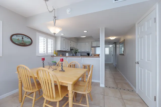 a view of a dining room with furniture and a chandelier