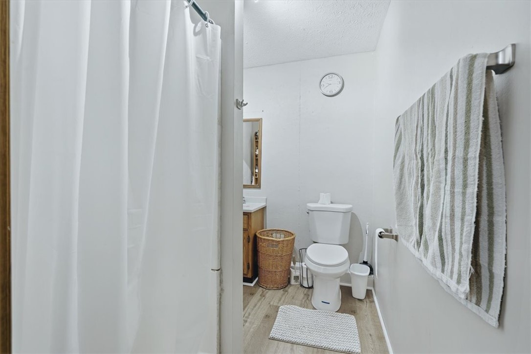 211 Cedar Ridge Drive Westminster, SC 29693 - Photo 23 of 34 A functional layout maximizes space within this cozy bathroom featuring wood-look flooring.