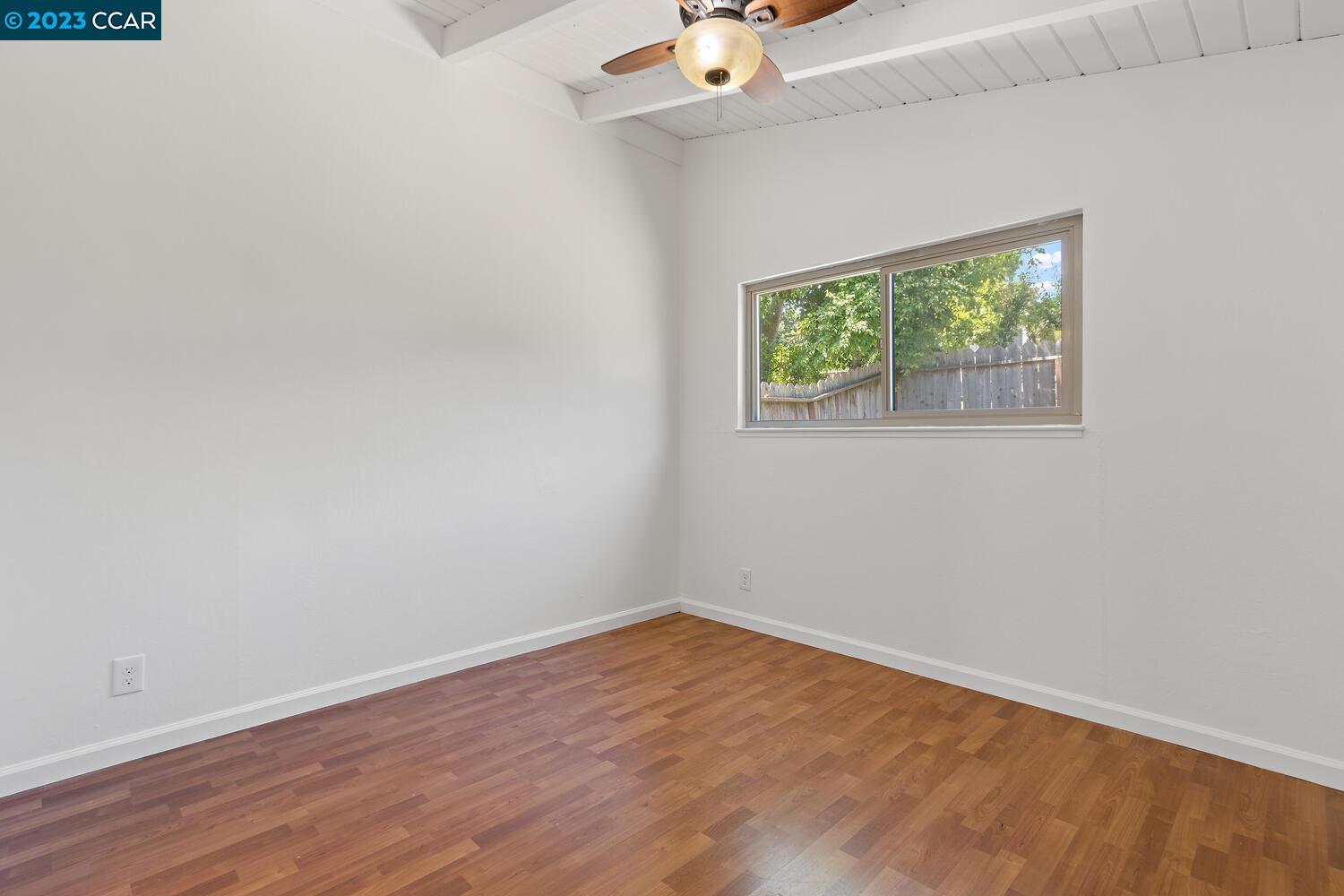 3374 Mildred Lane Lafayette, CA 94549 - Photo 14 of 34 an empty room with wooden floor and window