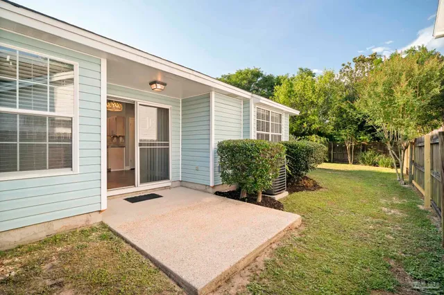 a backyard of a house with yard and tree