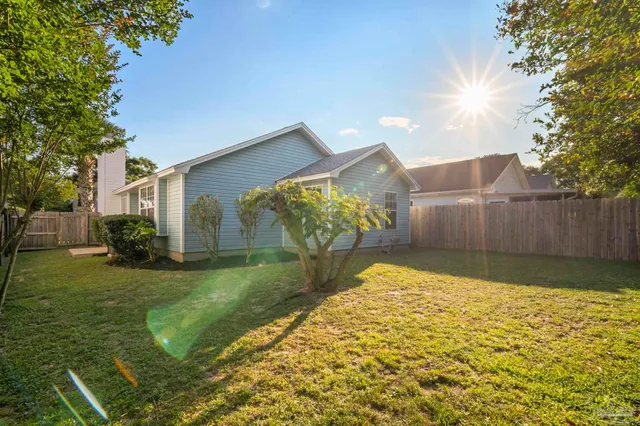 a backyard of a house with table and chairs