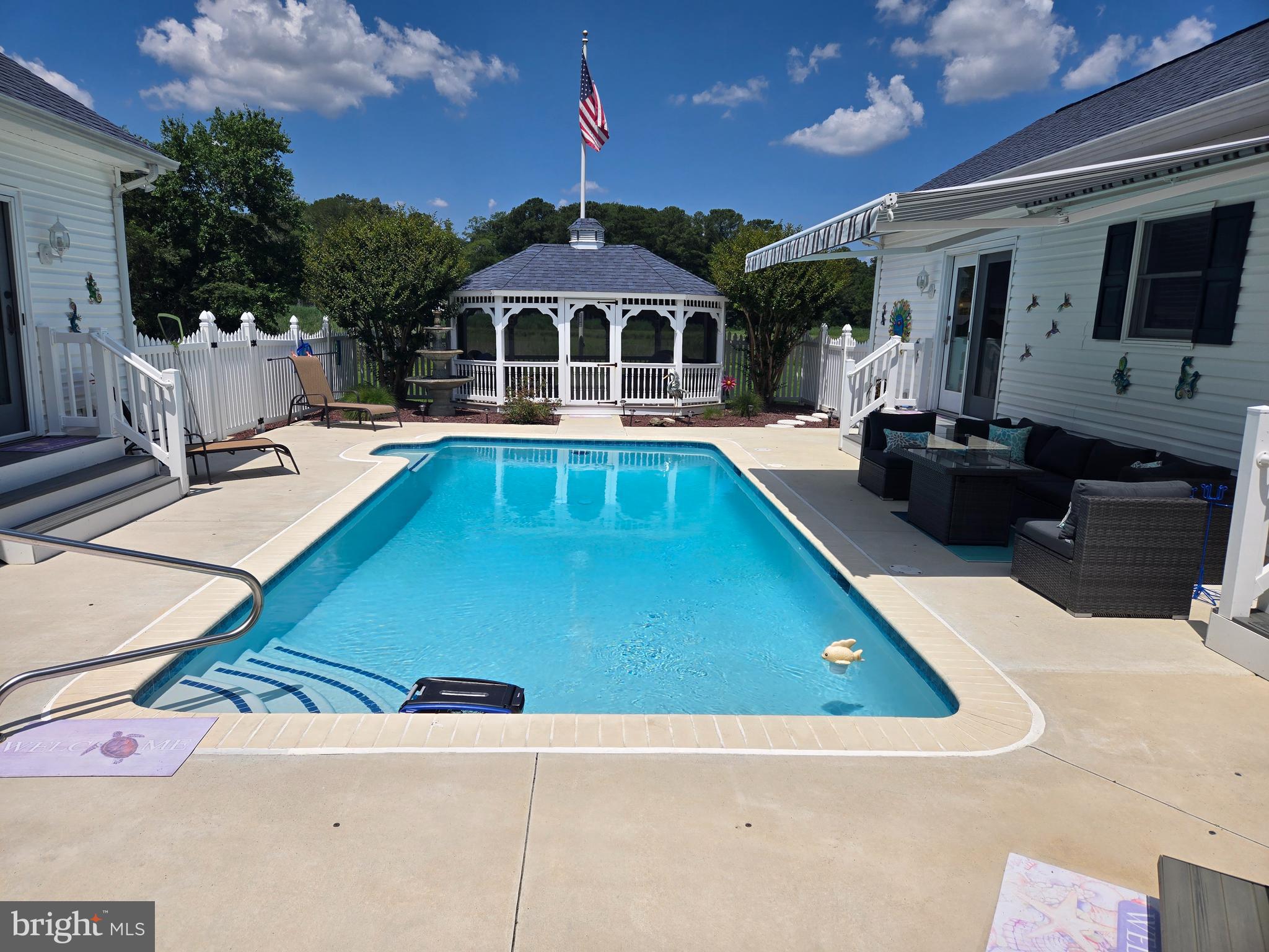 a view of swimming pool with seating space