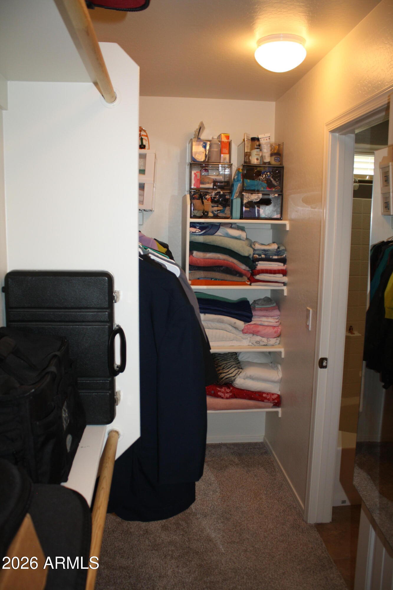 10225 West Camelback Road, Unit 19 Phoenix, AZ 85037 - Photo 38 of 51 a view of walk in closet with clothes and shoes