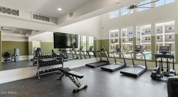 a living room with gym equipment and a large window