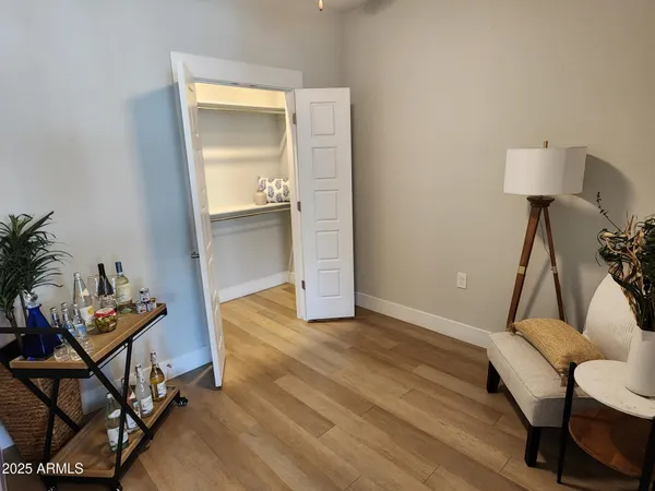a view of a room with furniture and wooden floor