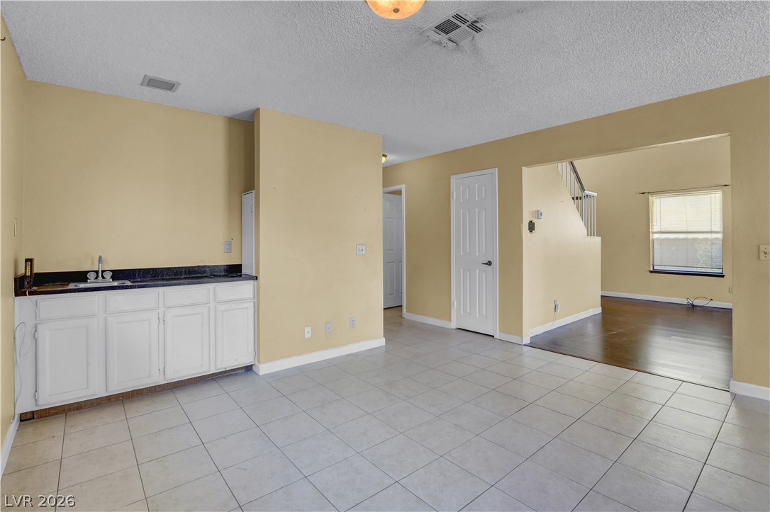 6440 Hartwood Road Las Vegas, NV 89108 - Photo 11 of 59 A versatile open-concept living space features a wet bar and easy transition to the dining area.