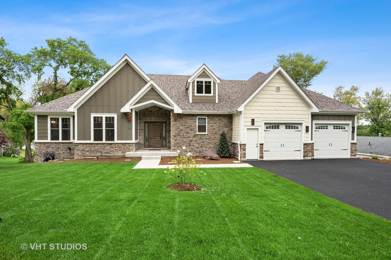 a front view of a house with a yard and garage