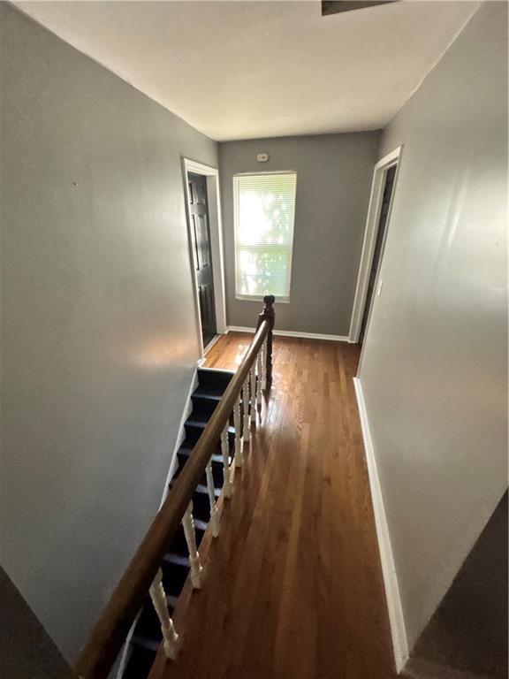335 Cedarhurst Street Pittsburgh, PA 15210 - Photo 22 of 28 a view of a hallway with wooden floor and stairs
