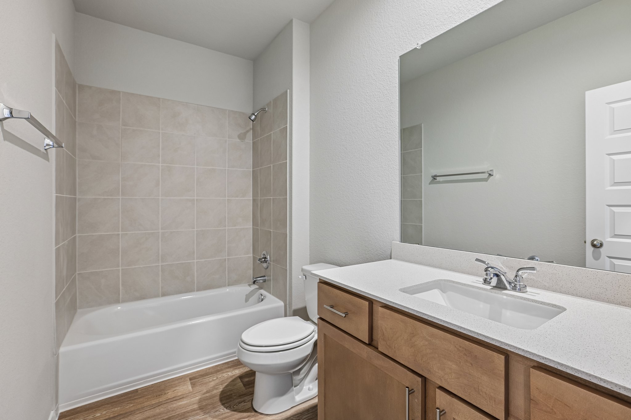 5513 Sacra Cove Austin, TX 78747 - Photo 33 of 37 a bathroom with a bathtub shower sink vanity mirror and toilet