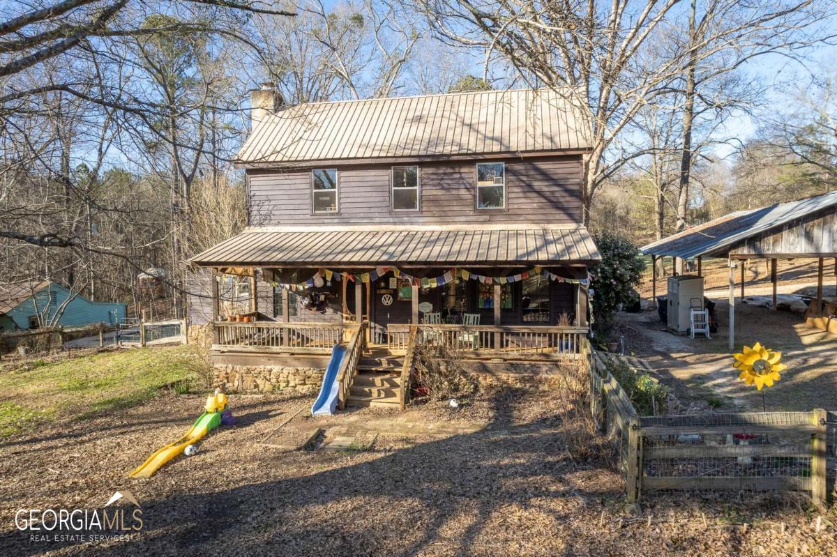 1401 Beaverdam Road Madison, GA 30650 - Photo 1 of 1 a front view of a house with garden