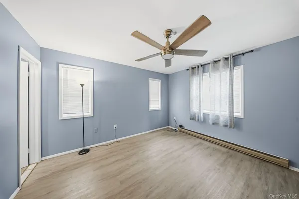 a view of a livingroom with a flat screen tv and a ceiling fan