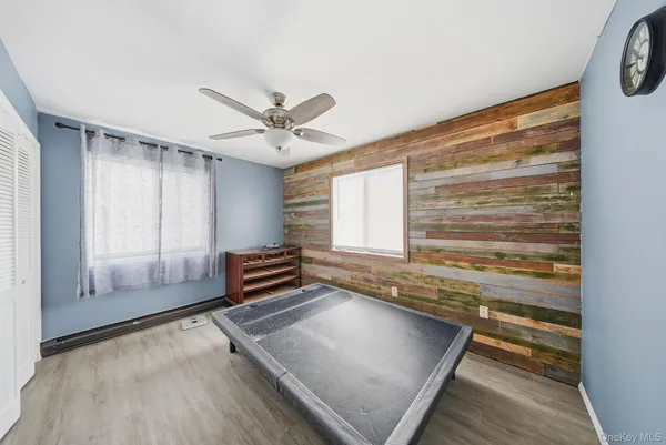 a view of a house with a wooden deck and a yard