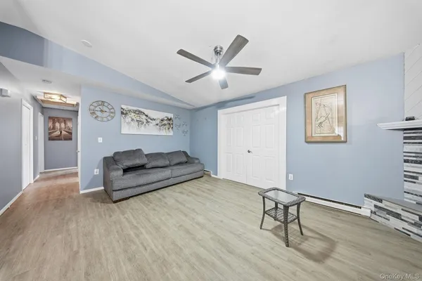 a living room with furniture and a wooden floor