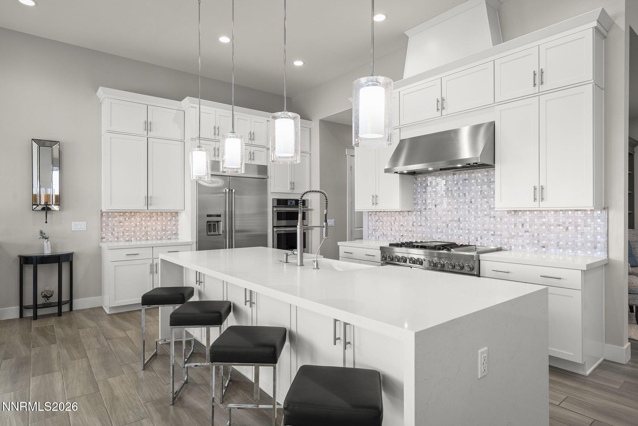 2945 Ruby Desert Drive Reno, NV 89521 - Photo 14 of 41 a large kitchen with stainless steel appliances kitchen island granite countertop a stove a sink a dining table and chairs