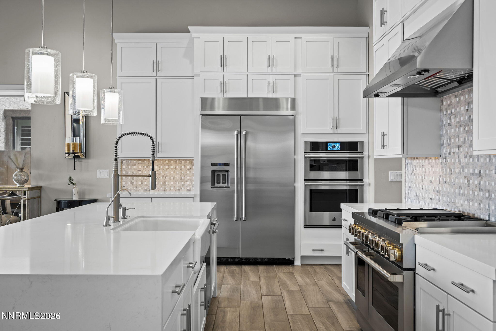 2945 Ruby Desert Drive Reno, NV 89521 - Photo 16 of 41 a kitchen with stainless steel appliances a refrigerator sink and white cabinets