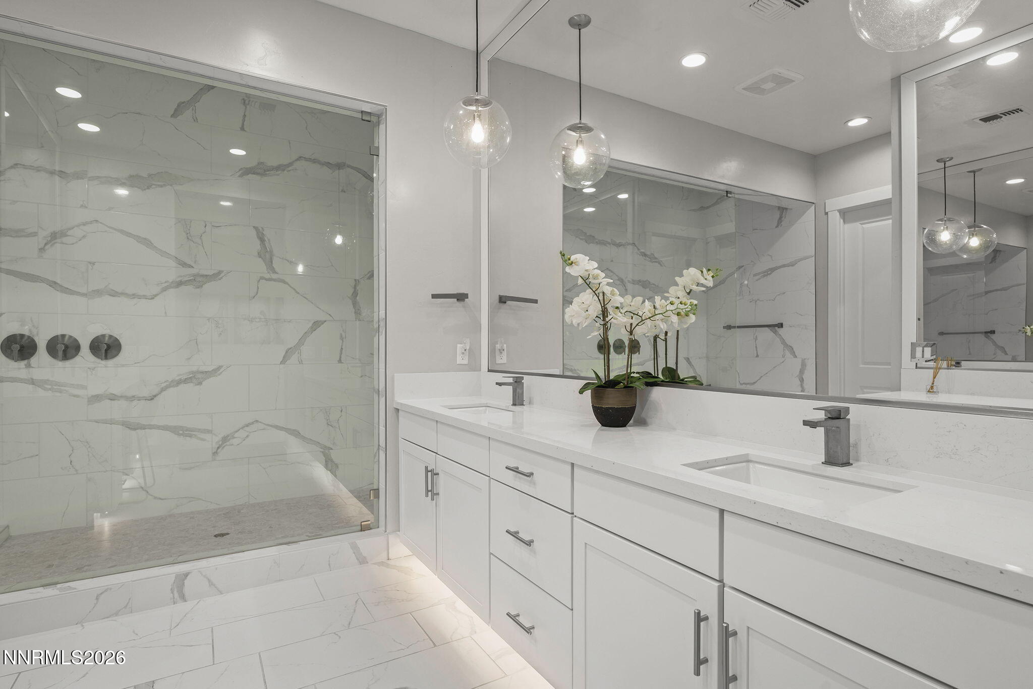 2945 Ruby Desert Drive Reno, NV 89521 - Photo 23 of 41 a bathroom with a double vanity sink mirror and shower