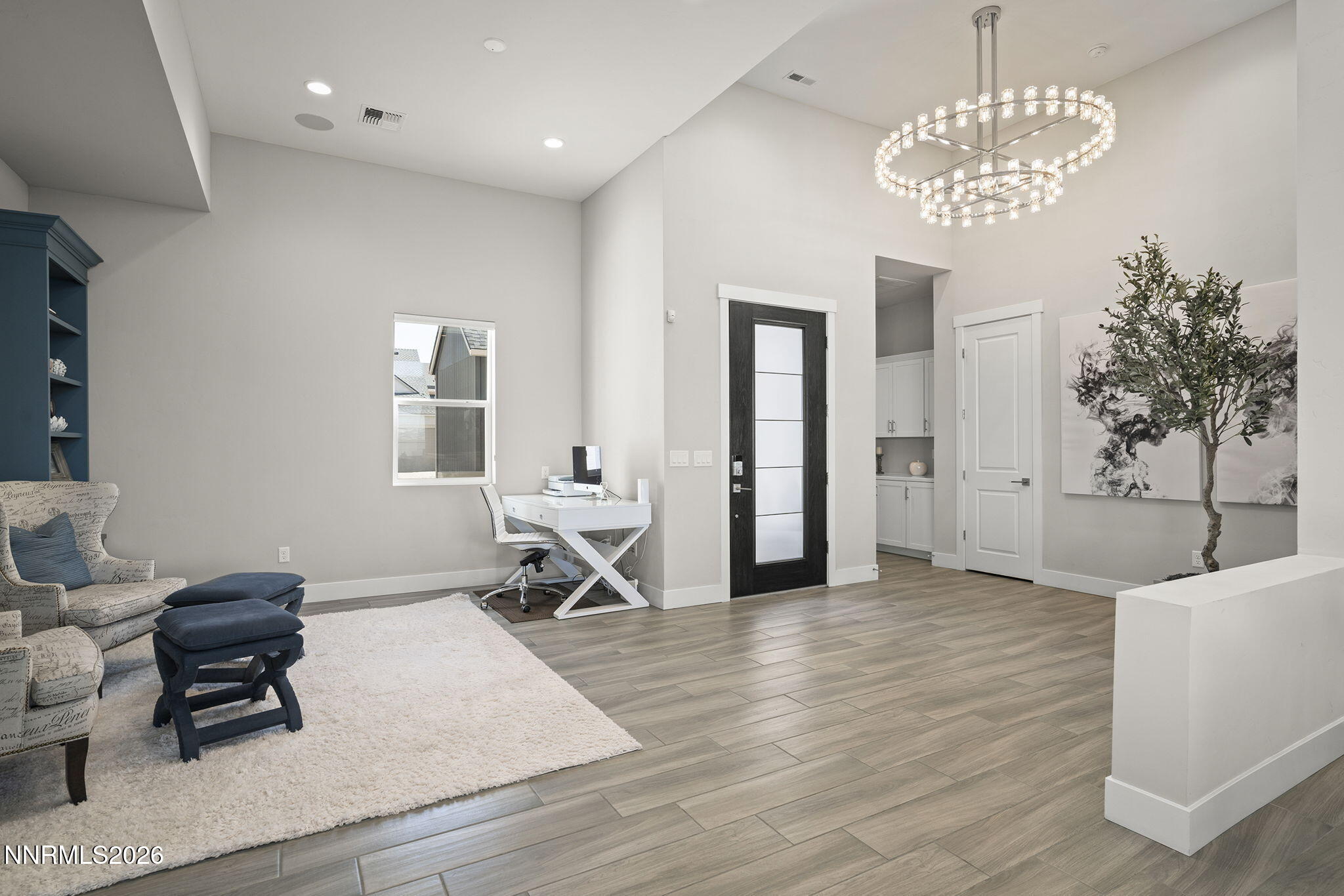 2945 Ruby Desert Drive Reno, NV 89521 - Photo 5 of 41 a view of a livingroom with a dinning area hardwood floor and a chandelier