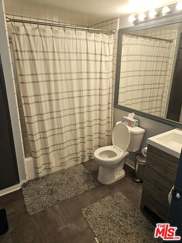 a bathroom with a toilet and shower