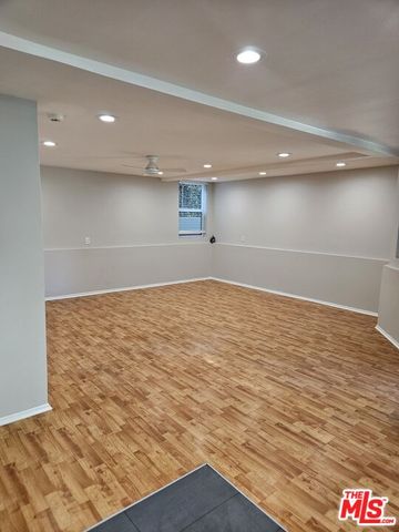 an empty room with wooden floor
