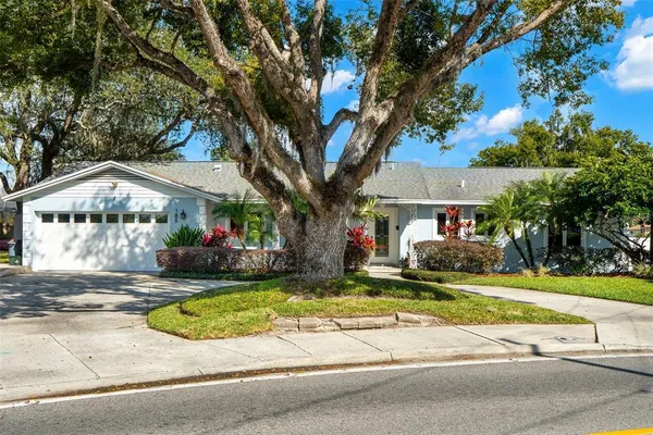 a view of a house with swimming pool and sitting area