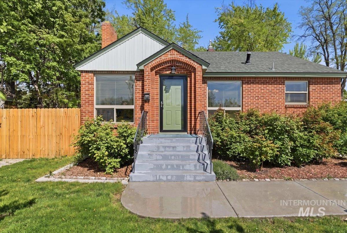 6710 West Ustick Road Boise, ID 83704 - Photo 2 of 42 Brick exterior featuring an arched entryway and a contrasting green door