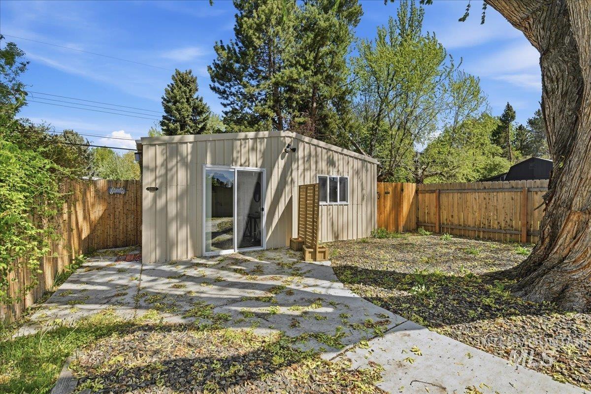 6710 West Ustick Road Boise, ID 83704 - Photo 29 of 42 Detached outbuilding with board and batten siding, a single window, and a sliding glass door