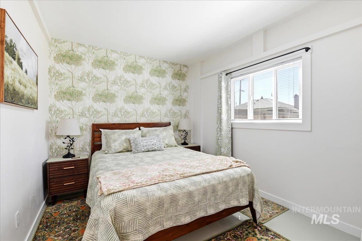 6710 West Ustick Road Boise, ID 83704 - Photo 36 of 42 Accent wall featuring a botanical-patterned wallpaper