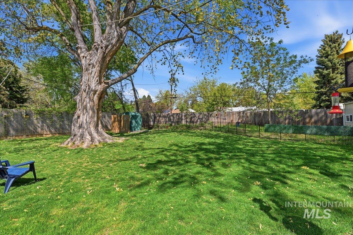 6710 West Ustick Road Boise, ID 83704 - Photo 41 of 42 Spacious backyard featuring a large mature tree providing natural shade