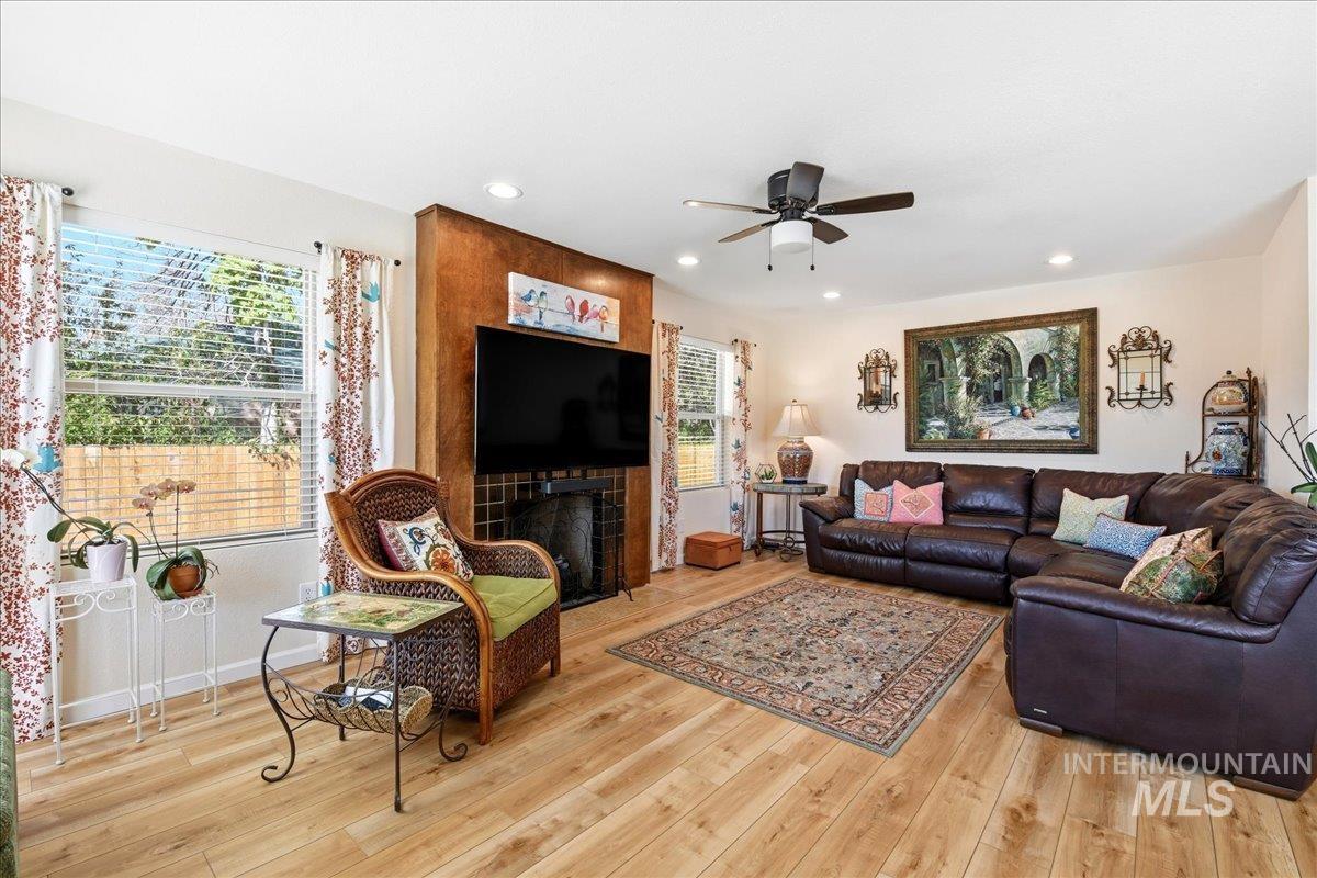 6710 West Ustick Road Boise, ID 83704 - Photo 6 of 42 Living area featuring wood-finish flooring, recessed lighting, and a ceiling fan with integrated light