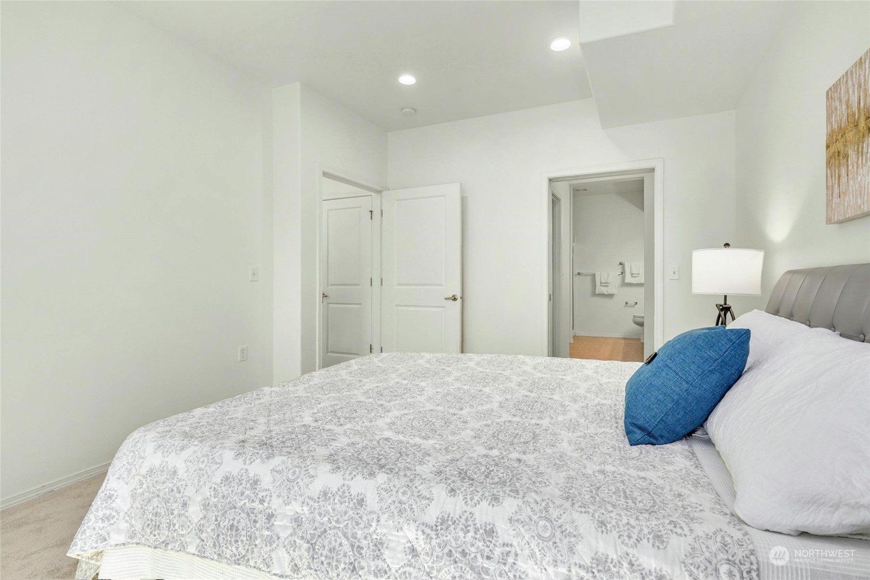 15 164th Street Southwest, Unit J4 Bothell, WA 98012 - Photo 17 of 39 a bedroom with a large bed and a chandelier