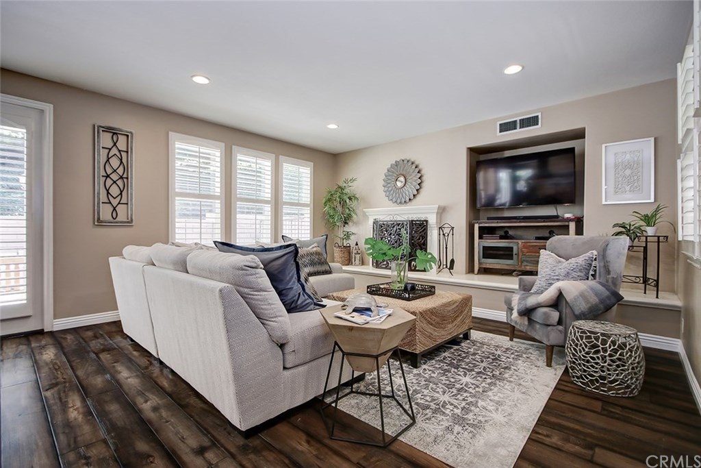 2911 Hawk Pointe Drive Fullerton, CA 92833 - Photo 18 of 55 Main Floor Family Room Features: Recessed Lighting, Stone Surround Fireplace, Alcove Entertainment Space, Plantation Shutters, and Hardwood Flooring.