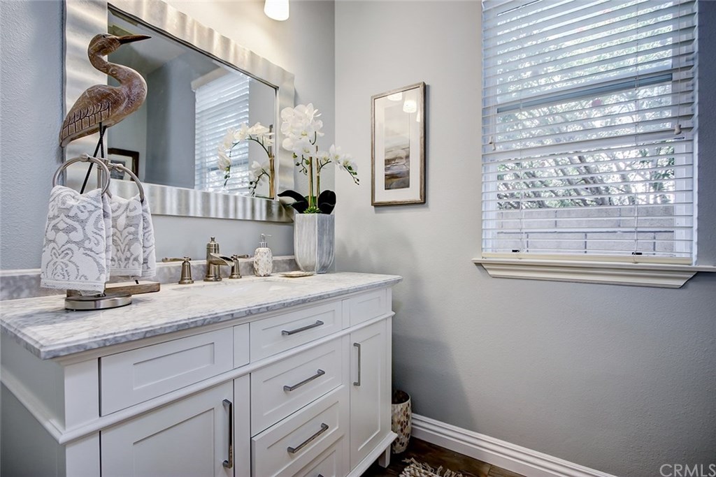 2911 Hawk Pointe Drive Fullerton, CA 92833 - Photo 28 of 55 Main Floor Guest Powder Room Remodeled with Stone Cabinetry, Custom Vanity, and Hardwood Flooring.