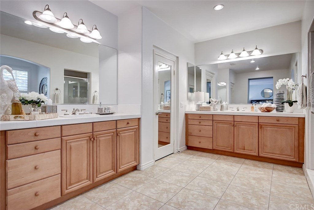 2911 Hawk Pointe Drive Fullerton, CA 92833 - Photo 34 of 55 Master Bathroom Area Features: Recessed Lighting, Separate Sink Vanity Areas, Tile Flooring, and Separate Mirrored Door Walk-In Closets.