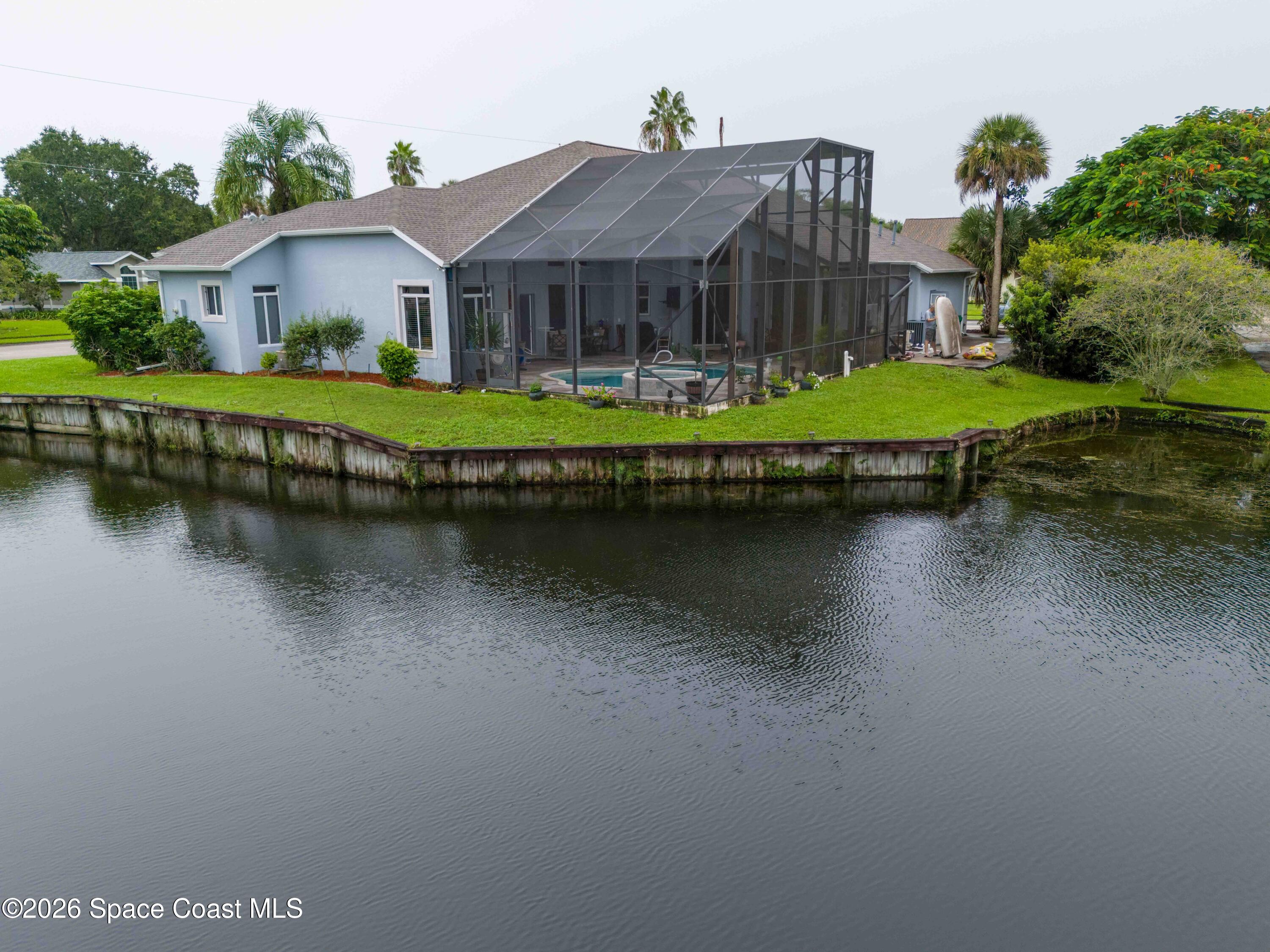 4635 Seminole Trail Merritt Island, FL 32953 - Photo 2 of 2 a view of house with swimming pool next to a house