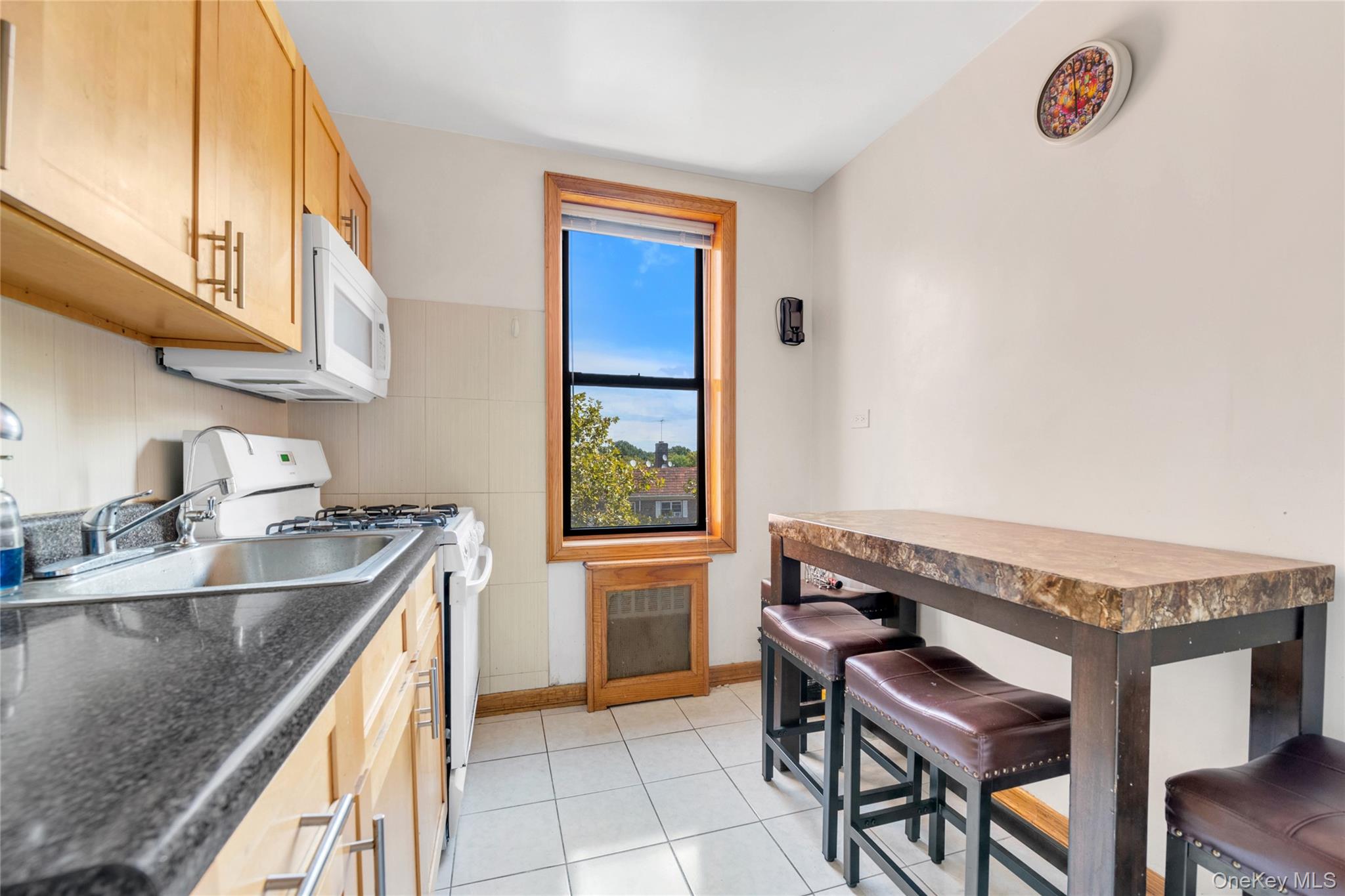 108-50 62nd Drive, Unit 3F Queens, NY 11375 - Photo 7 of 11 a kitchen with a stove a sink and a cabinets