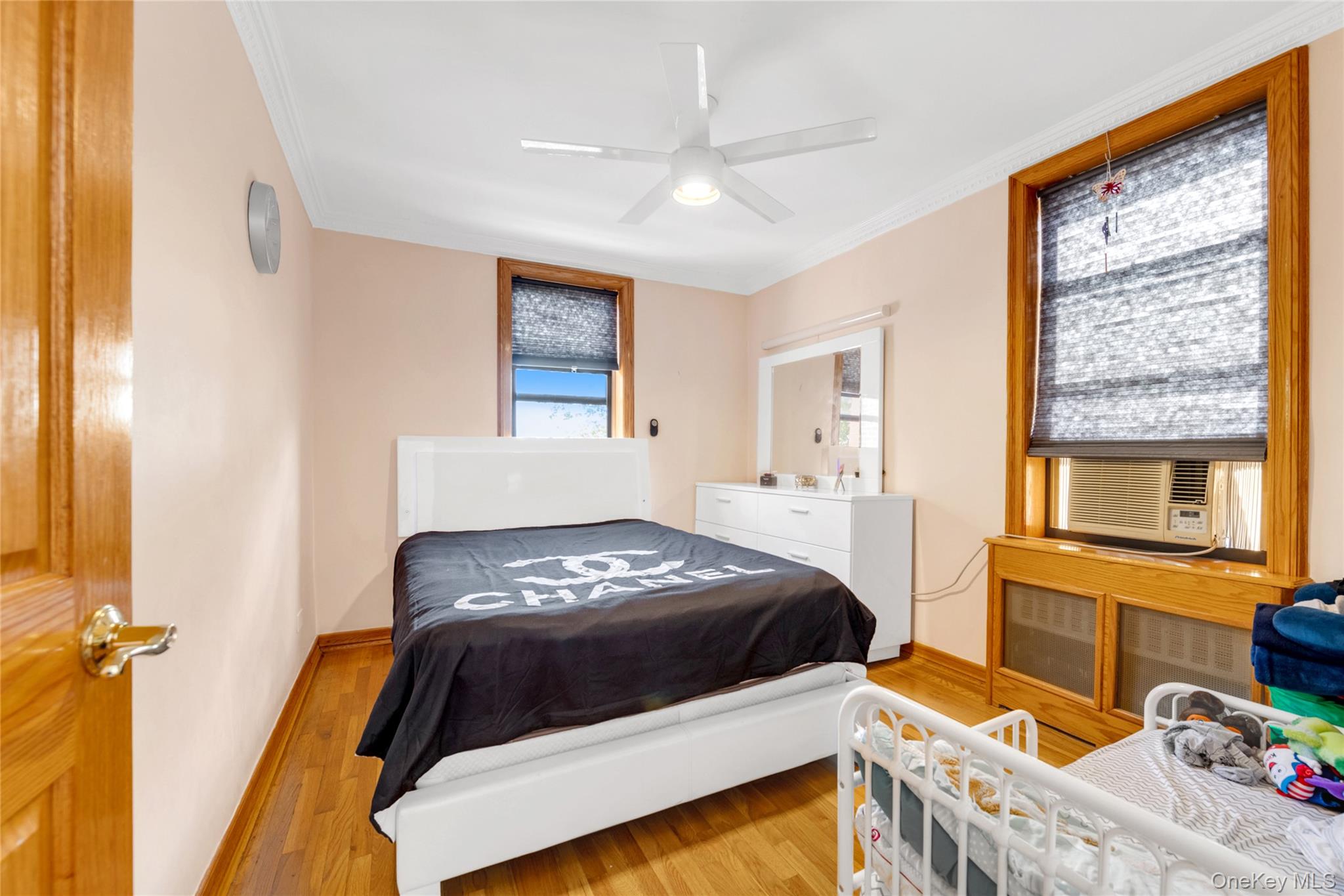 108-50 62nd Drive, Unit 3F Queens, NY 11375 - Photo 8 of 11 a bedroom with a bed and a window