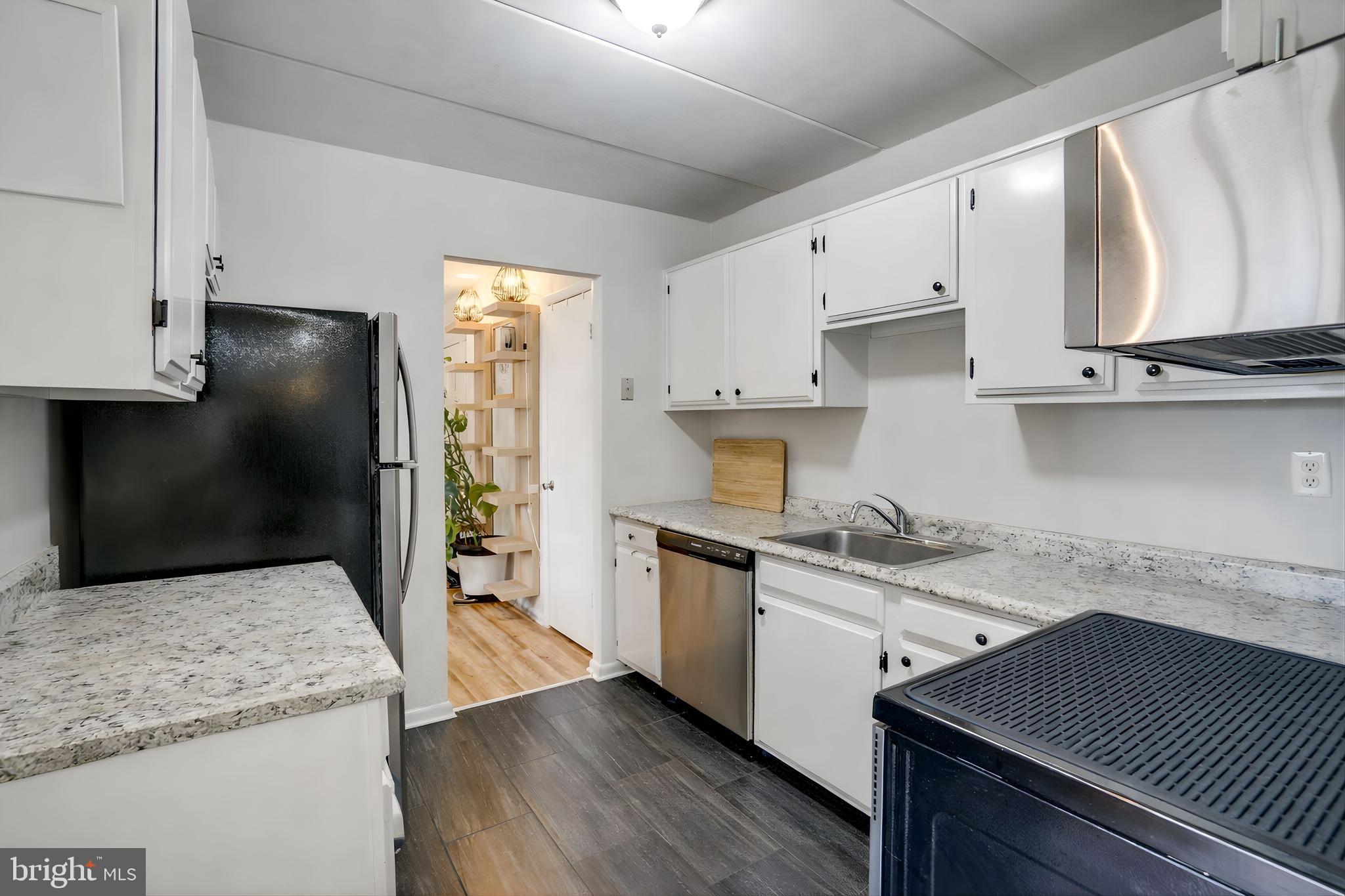 6240 Edsall Road, Unit 202 Alexandria, VA 22312 - Photo 2 of 13 a kitchen with stainless steel appliances granite countertop a sink stove and refrigerator