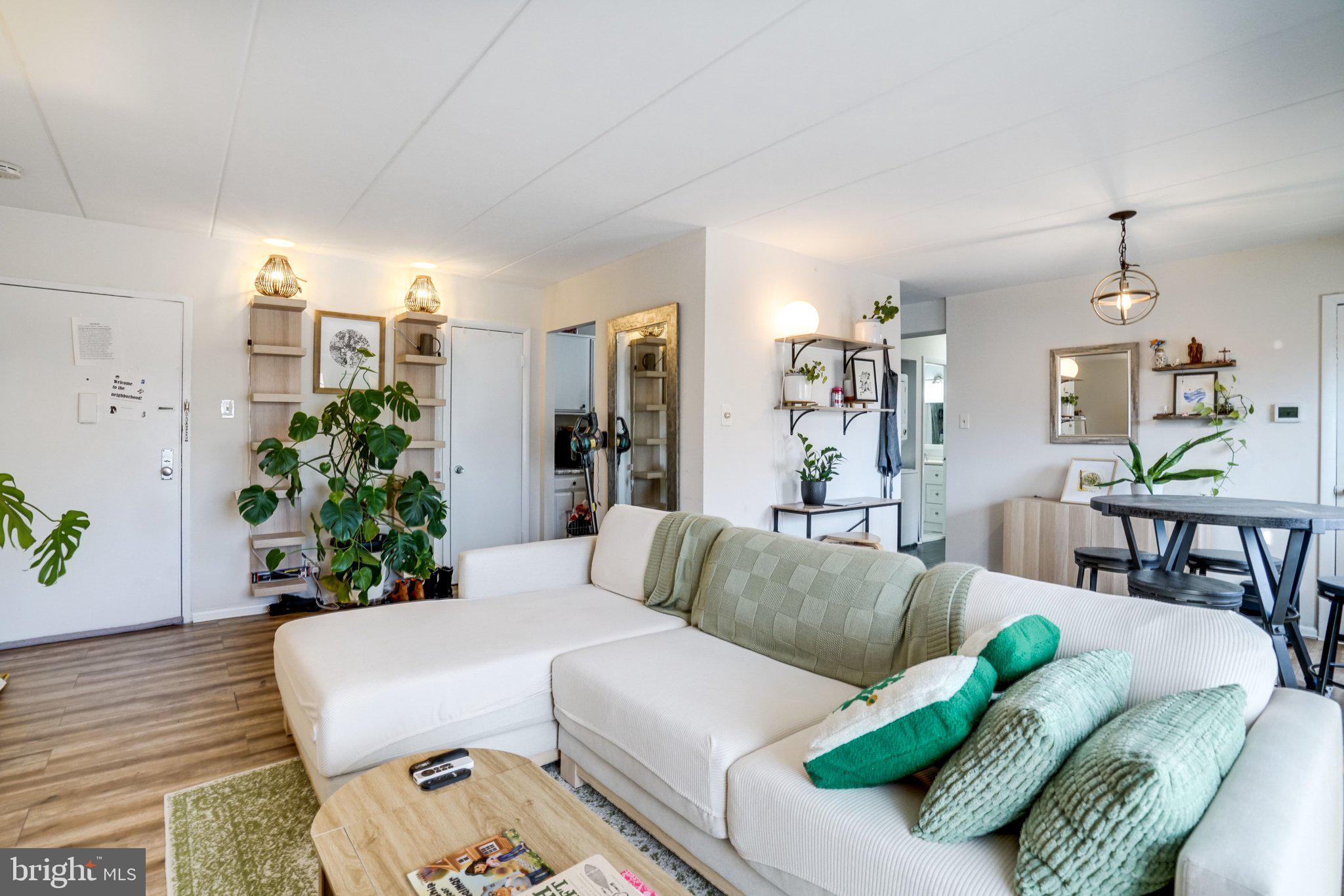 6240 Edsall Road, Unit 202 Alexandria, VA 22312 - Photo 7 of 13 a living room with furniture and a wooden floor