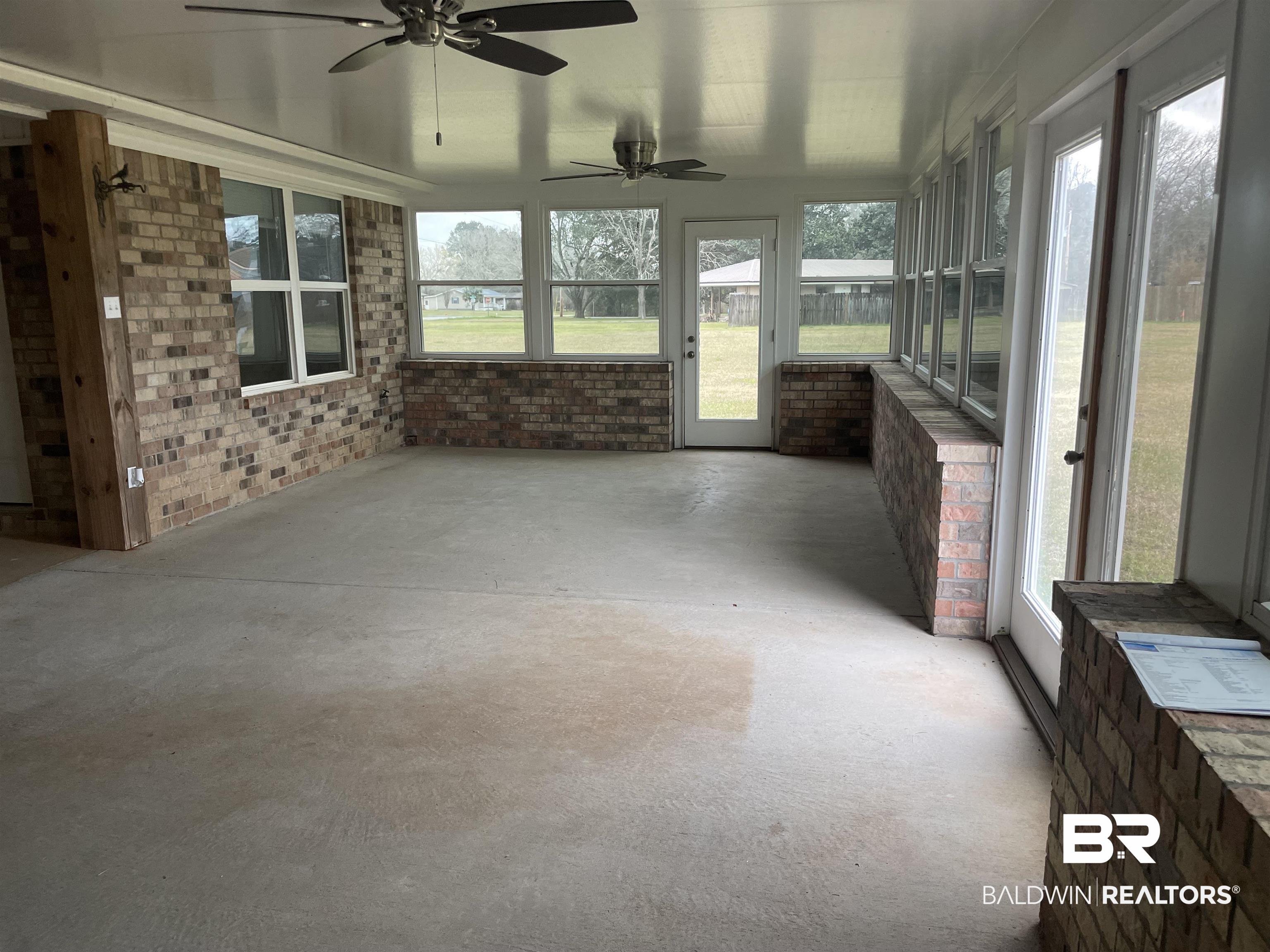 23575 Fountain Street Robertsdale, AL 36567 - Photo 17 of 19 Unfurnished sunroom featuring a wealth of natural light