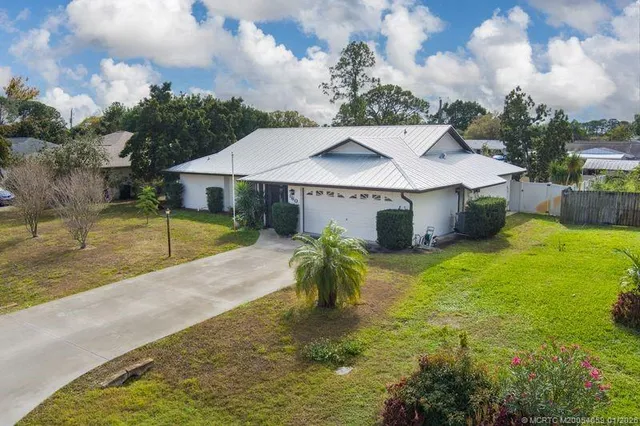 a view of a house with swimming pool and sitting area