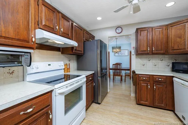 a kitchen with stainless steel appliances granite countertop a stove and a refrigerator
