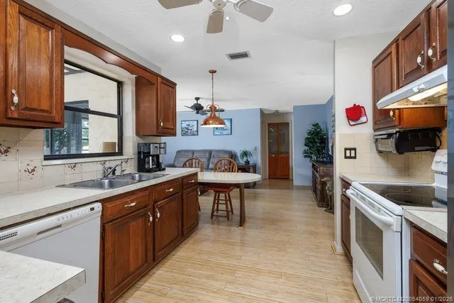 a kitchen with stainless steel appliances granite countertop a sink and cabinets