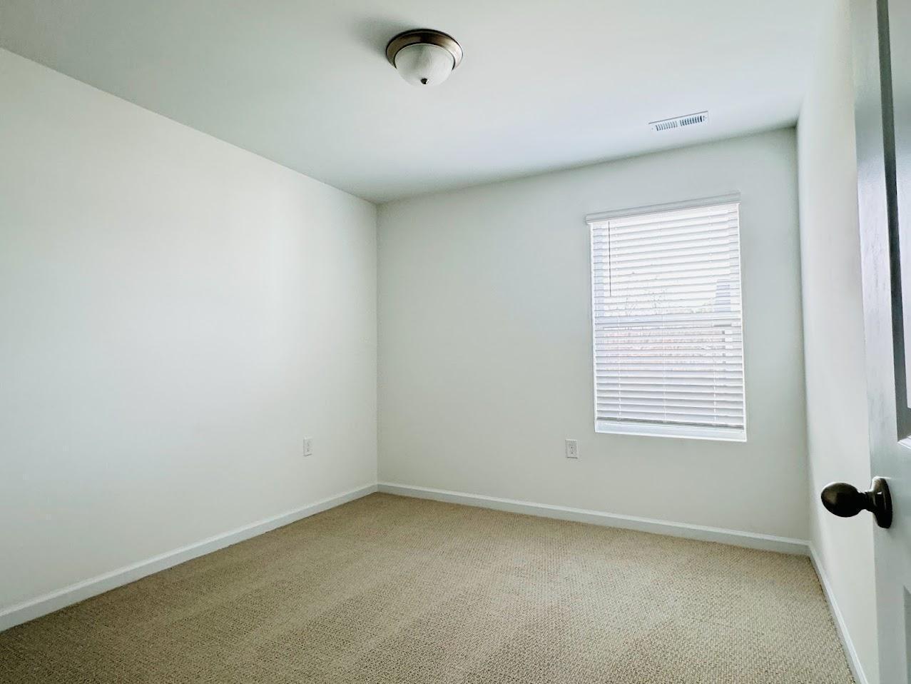 428 Sustainable Way Raleigh, NC 27610 - Photo 17 of 22 an empty room with a window