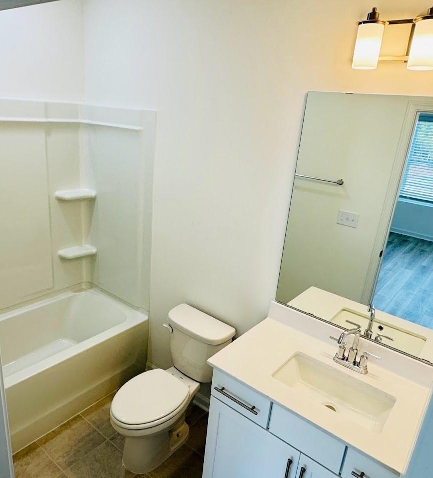 428 Sustainable Way Raleigh, NC 27610 - Photo 22 of 22 a bathroom with a sink toilet and shower