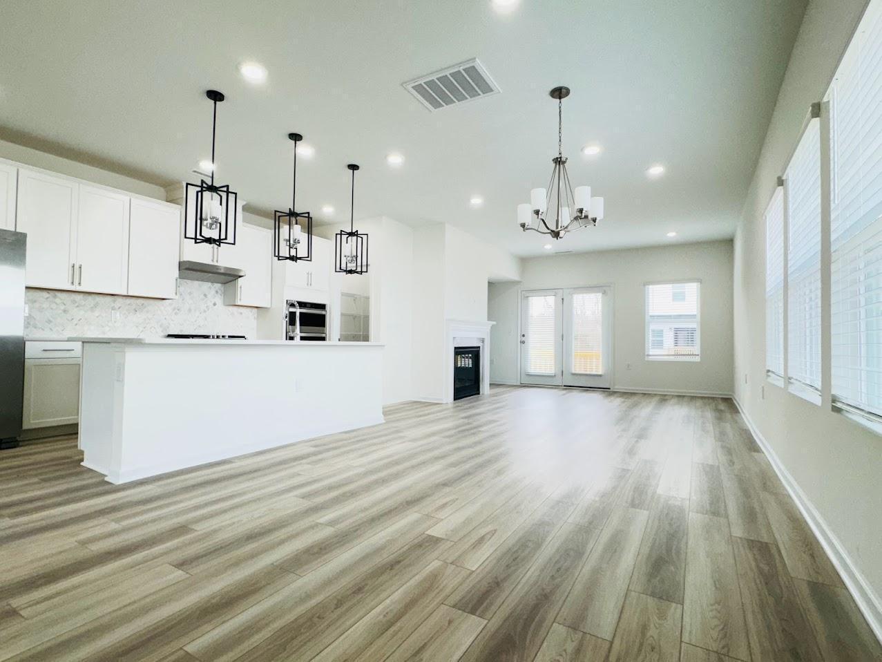 428 Sustainable Way Raleigh, NC 27610 - Photo 4 of 22 a view of a kitchen with wooden floor and windows