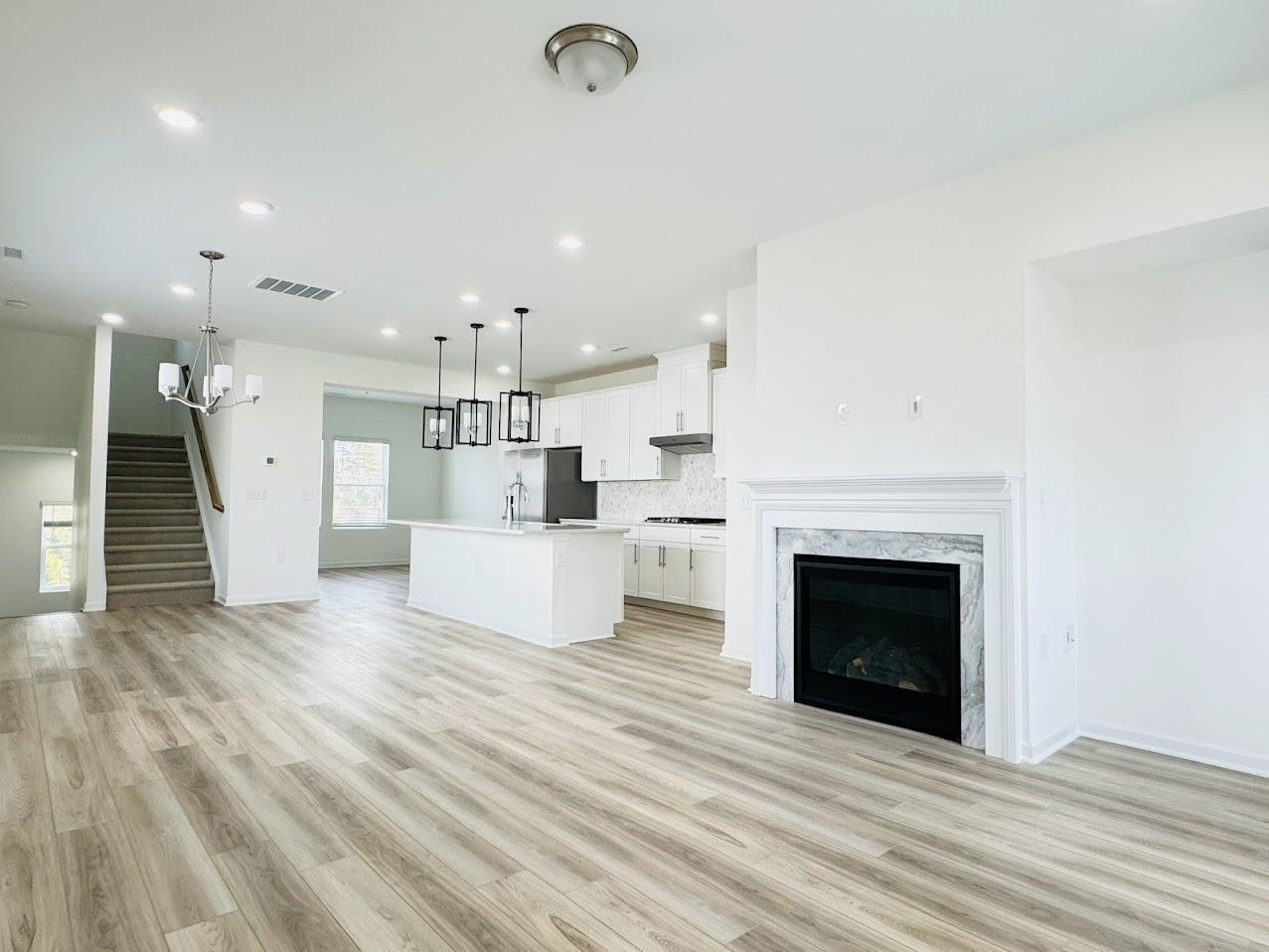 428 Sustainable Way Raleigh, NC 27610 - Photo 5 of 22 a view of a kitchen with furniture and a fireplace