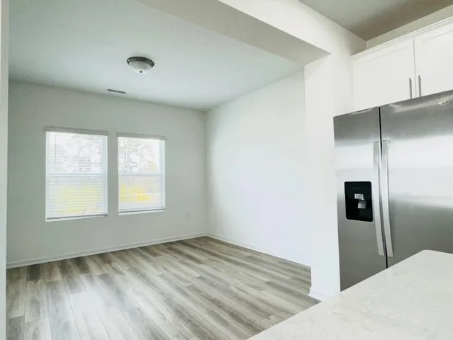 a view of a kitchen with a sink and refrigerator