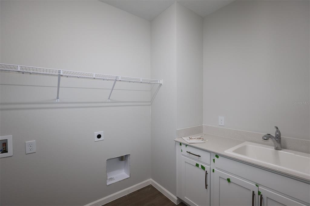 5184 Prairie Preserve Run St. Cloud, FL 34772 - Photo 11 of 36 a bathroom with a sink and cabinets