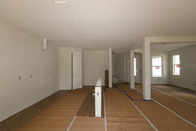 a view of a room with wooden floor